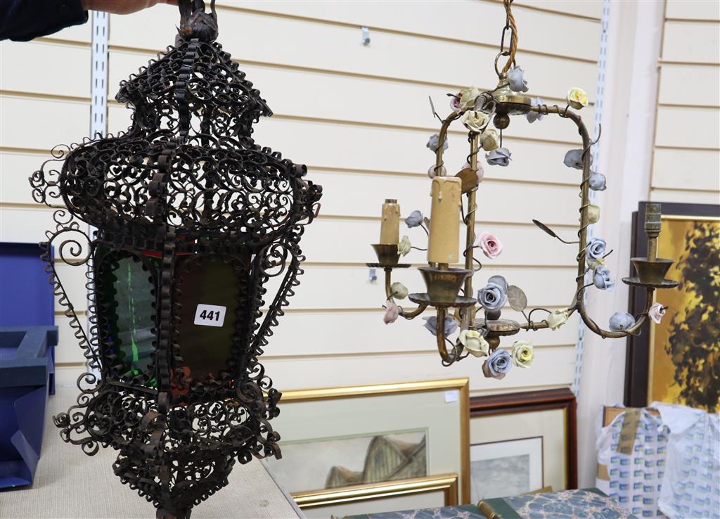 An Italian wrought iron and coloured glass hanging lantern and a brass chandelier, mounted with porcelain, lantern approximately 60cm l